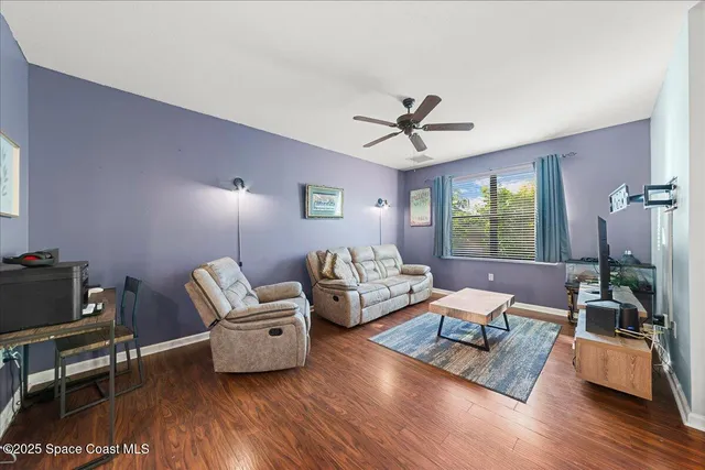 a living room with furniture and wooden floor