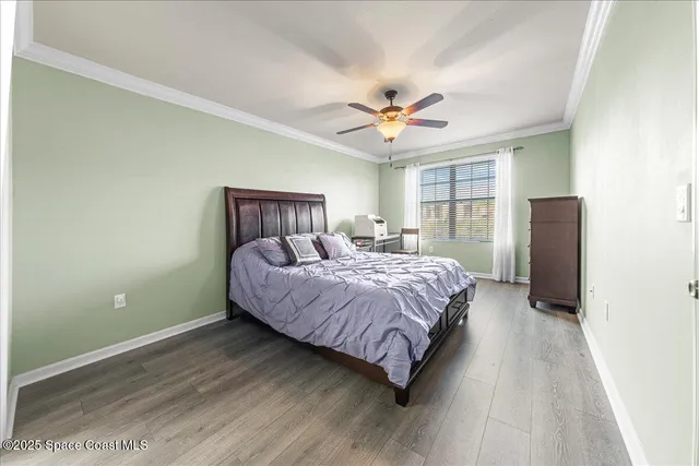 a spacious bedroom with a bed and a chandelier