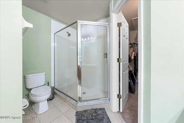 a bathroom with a glass shower door