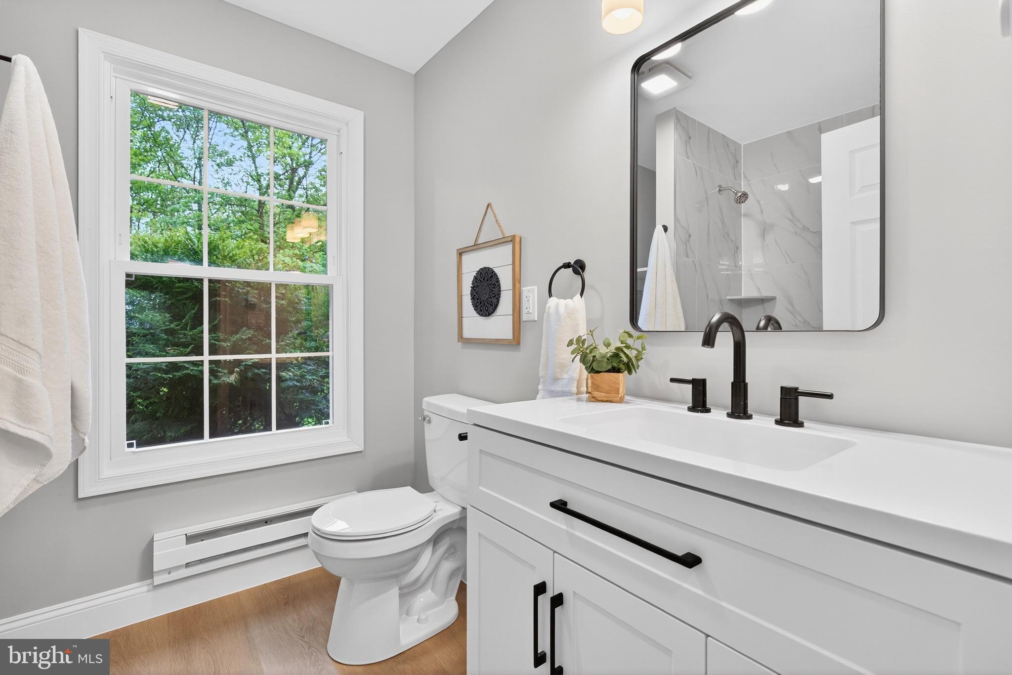 503 Whitman Lane Middletown, PA 17057 - Photo 41 of 58 a bathroom with a toilet a sink a mirror and a window