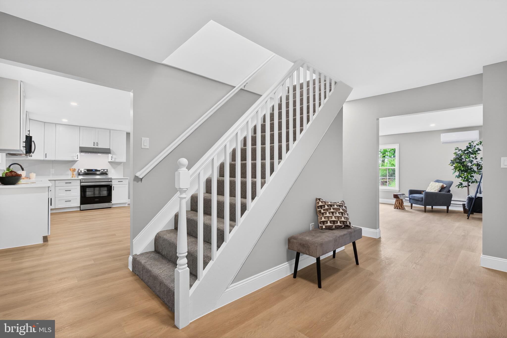 503 Whitman Lane Middletown, PA 17057 - Photo 57 of 58 a view of staircase and living room with wooden floor and a kitchen view