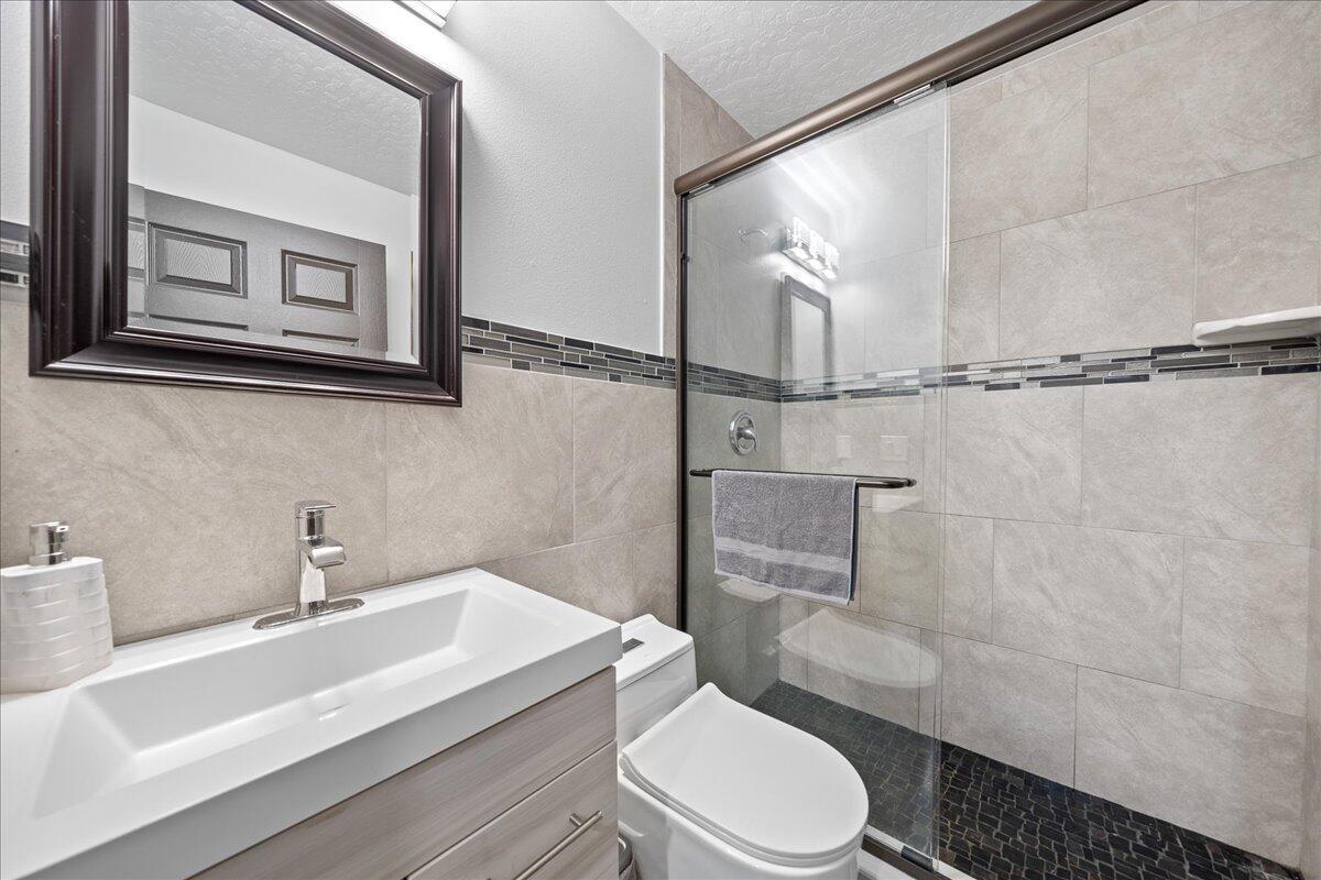 613 Grant Road Palm Bay, FL 32909 - Photo 12 of 40 a bathroom with a sink a toilet and shower