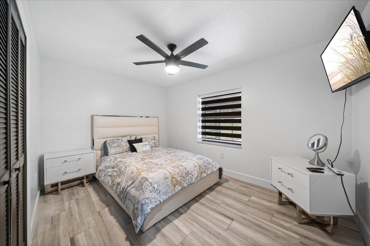 613 Grant Road Palm Bay, FL 32909 - Photo 13 of 40 a bedroom with a bed and a flat screen tv