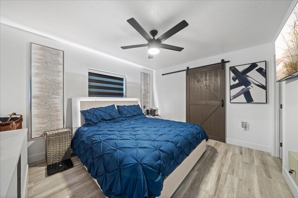 613 Grant Road Palm Bay, FL 32909 - Photo 16 of 40 a bedroom with a bed and a ceiling fan