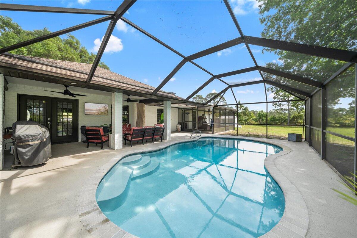 613 Grant Road Palm Bay, FL 32909 - Photo 18 of 40 a view of a swimming pool with a patio