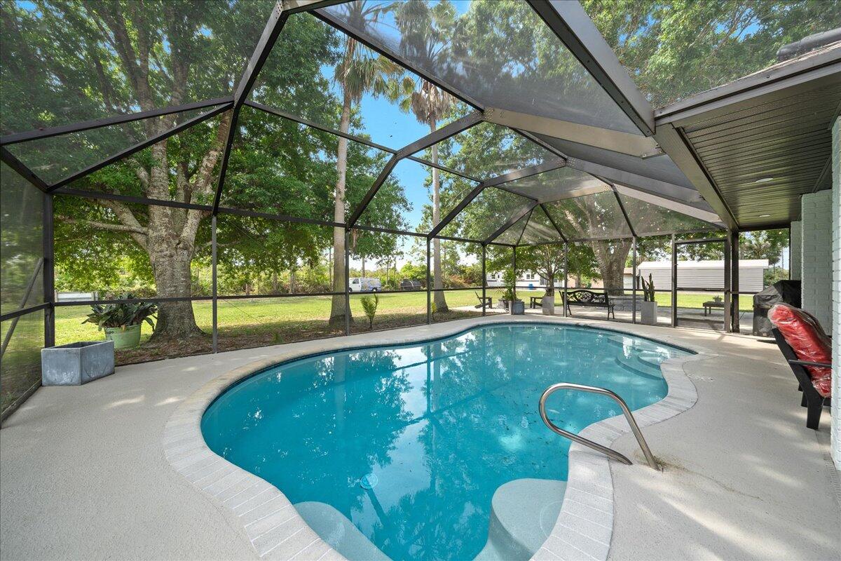 613 Grant Road Palm Bay, FL 32909 - Photo 19 of 40 a swimming pool with a outdoor seating