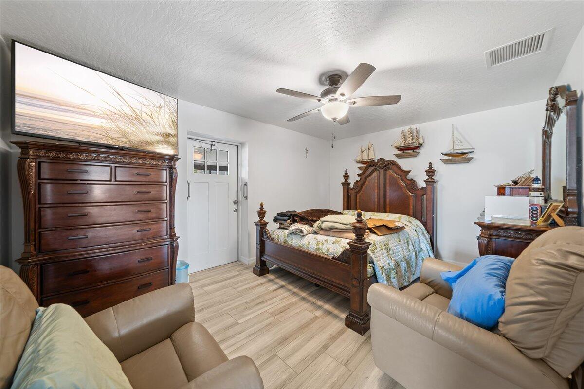 613 Grant Road Palm Bay, FL 32909 - Photo 29 of 40 a bedroom with a bed a couch and a window