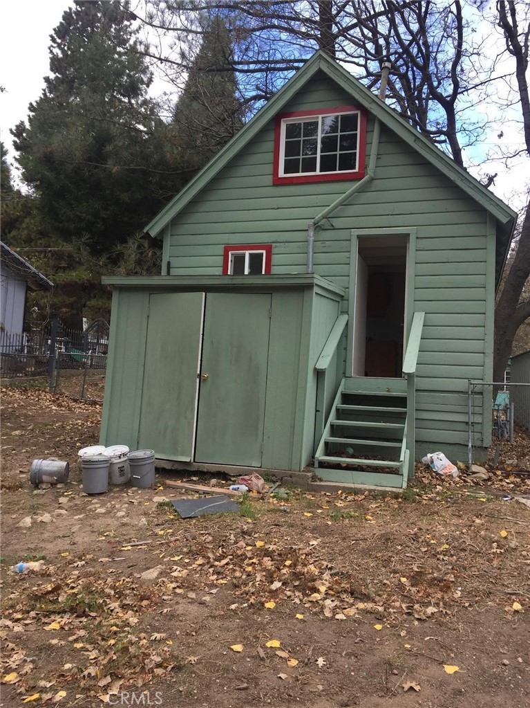 369 Log Crestline, CA 92325 - Photo 2 of 12 a front view of a house with a garage