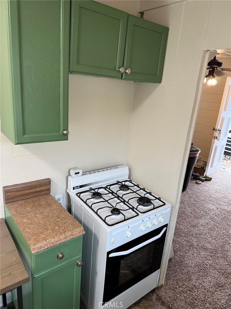 369 Log Crestline, CA 92325 - Photo 3 of 12 a kitchen with a stove and a microwave