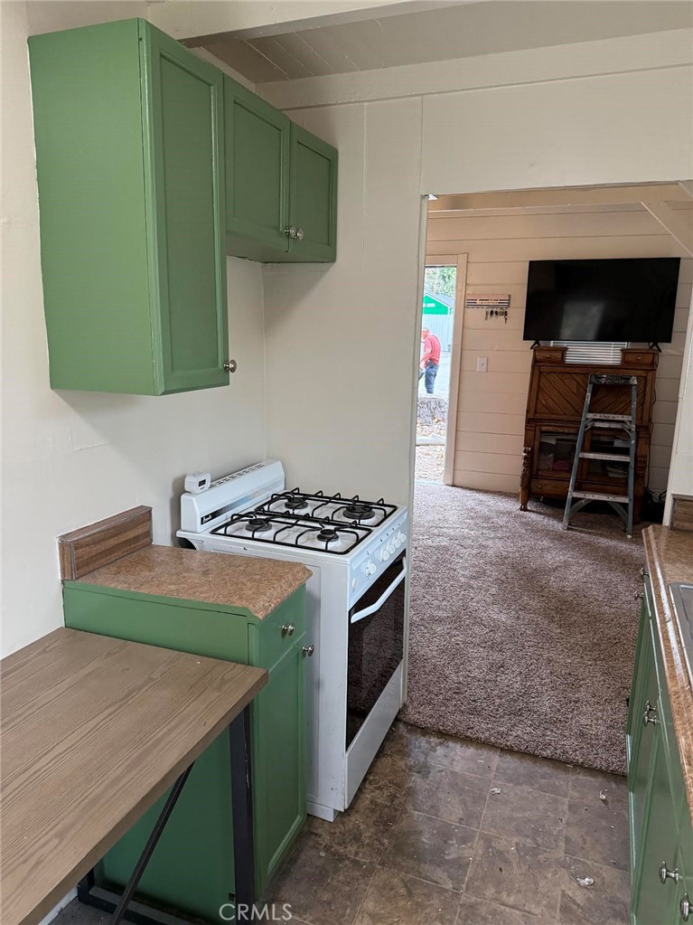 369 Log Crestline, CA 92325 - Photo 4 of 12 a kitchen with a stove and a microwave