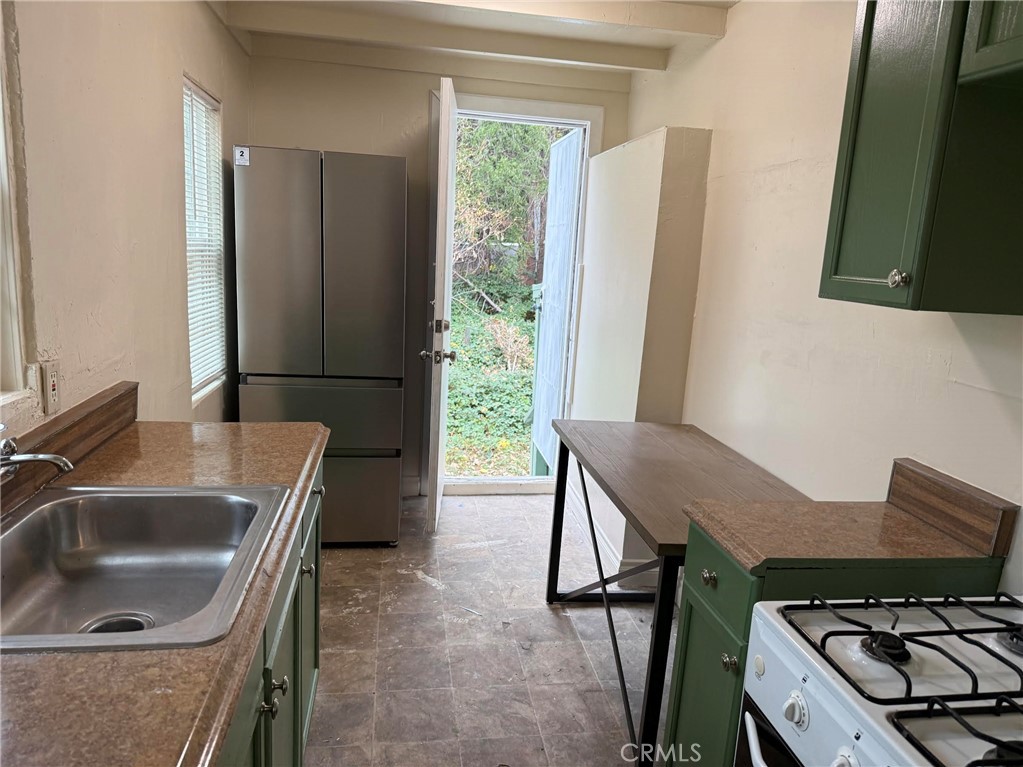 369 Log Crestline, CA 92325 - Photo 6 of 12 a kitchen with a sink cabinets and a stove top oven