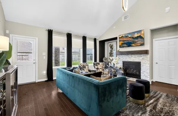 a living room with furniture and a fireplace