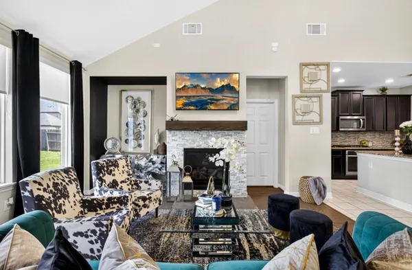 a living room with furniture fireplace and flat screen tv