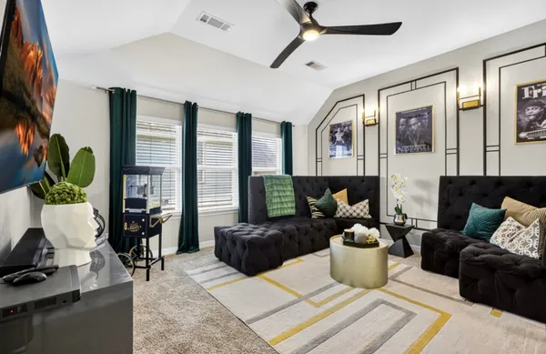 a living room with furniture fireplace and flat screen tv