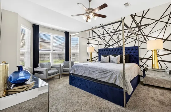 a bedroom with a bed couch and window