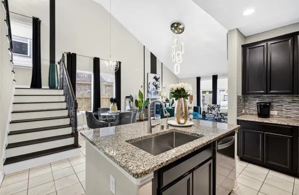 a kitchen with granite countertop a sink and a stove
