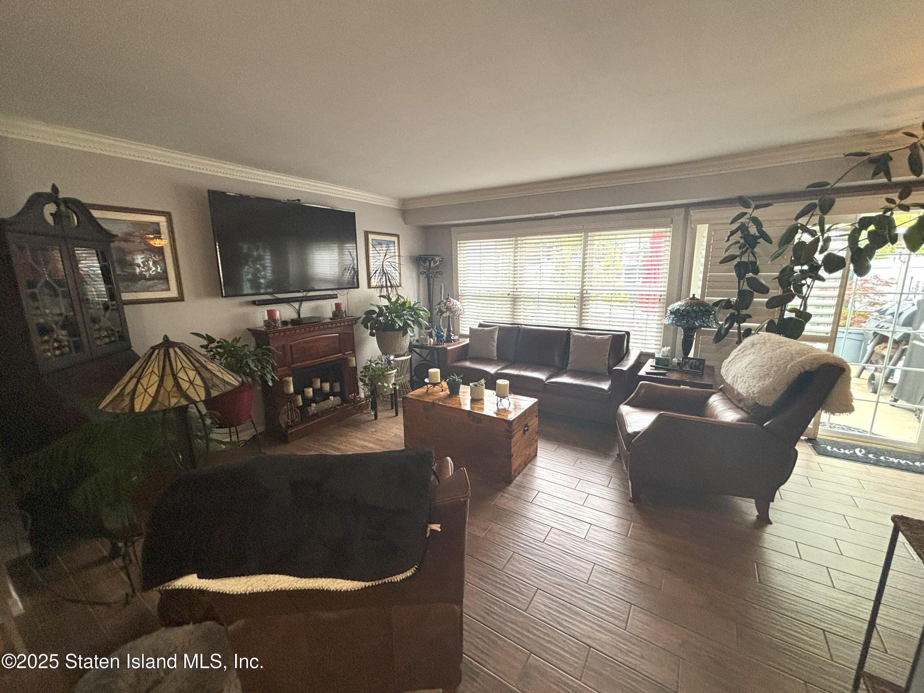 73 Hampton Green Staten Island, NY 10312 - Photo 18 of 28 a living room with furniture and a flat screen tv