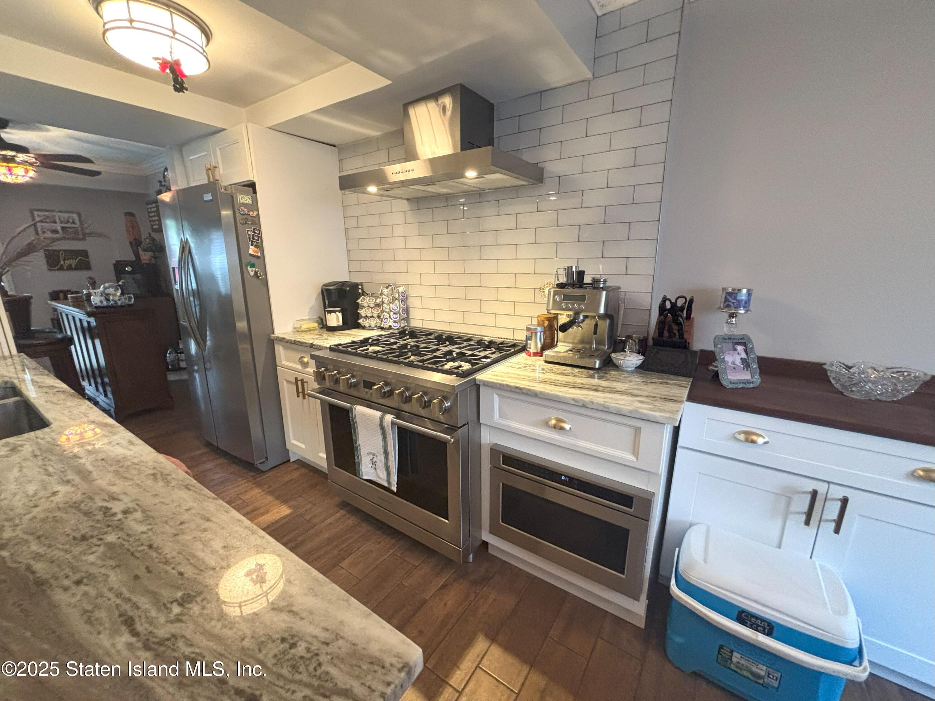 73 Hampton Green Staten Island, NY 10312 - Photo 6 of 28 a kitchen with granite countertop a stove and a sink