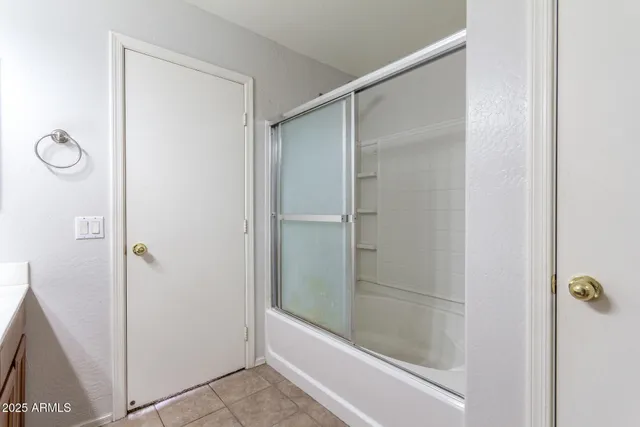 a bathroom with a glass shower door