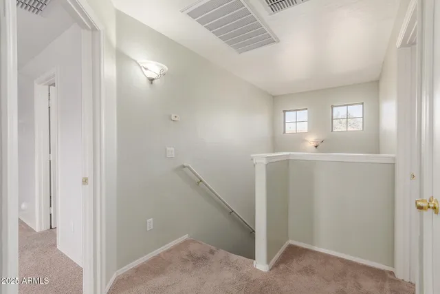 a view of a hallway and a sink and a window in a room