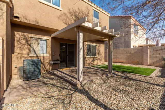 a view of a house with a small yard and wooden floor and fence