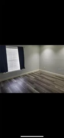 a view of room with wooden floor