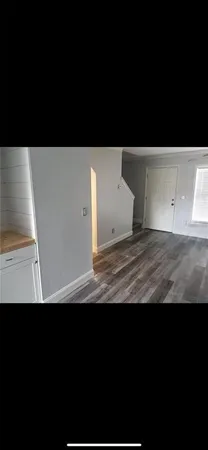 a view of a room with wooden floor