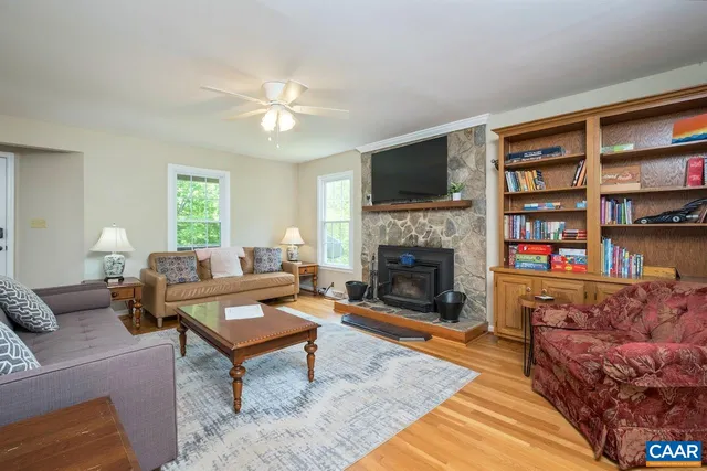 a living room with furniture a couch and wooden floor
