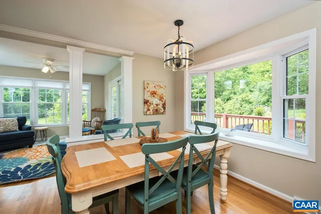 a large kitchen with stainless steel appliances granite countertop a stove a sink dishwasher and wooden cabinets with wooden floor