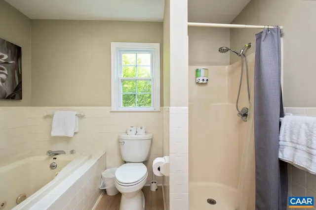 a bedroom with a bed and a television