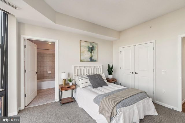 a bedroom with a bed and a painting