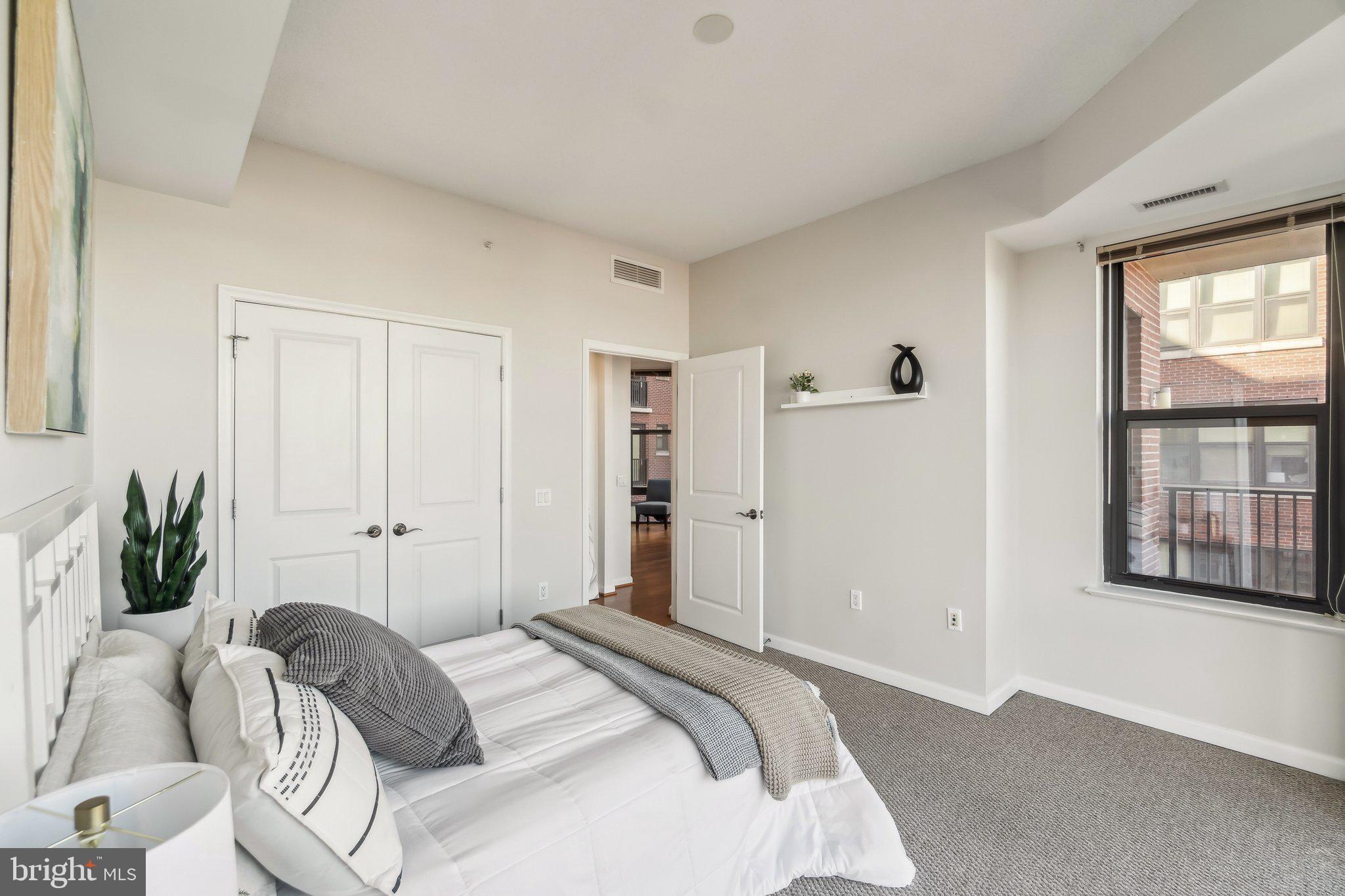 1390 Kenyon Street Northwest, Unit 510 Washington, DC 20010 - Photo 12 of 39 a bedroom with a bed and a window