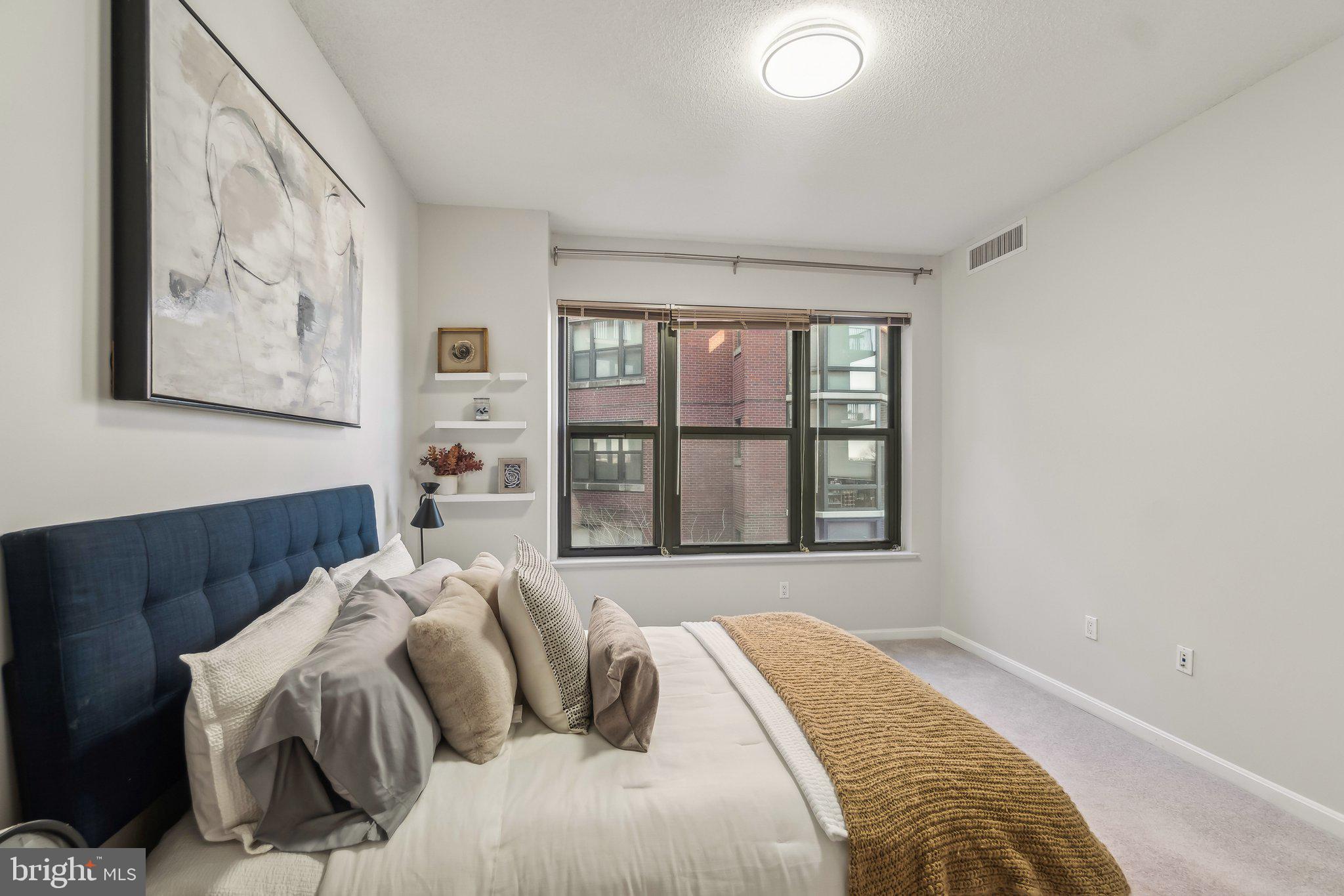 1390 Kenyon Street Northwest, Unit 510 Washington, DC 20010 - Photo 16 of 39 a bedroom with a bed and a large window