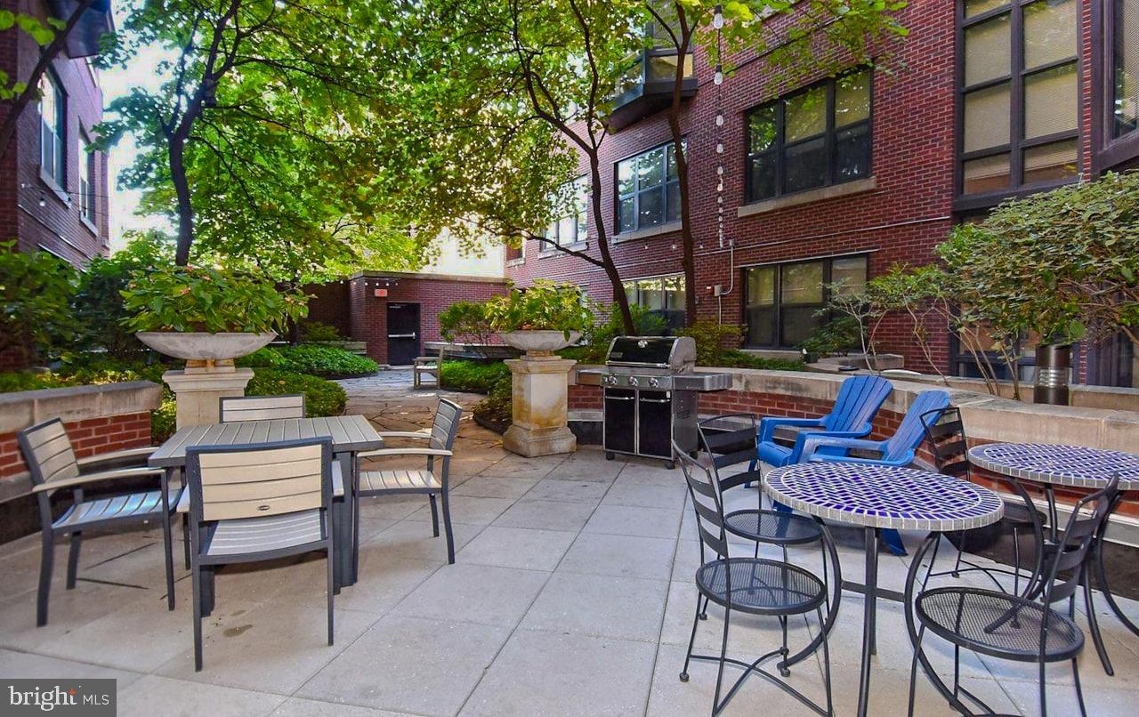 1390 Kenyon Street Northwest, Unit 510 Washington, DC 20010 - Photo 32 of 39 a backyard of a house with barbeque oven table and chairs