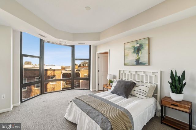 a bedroom with a large bed and a couch