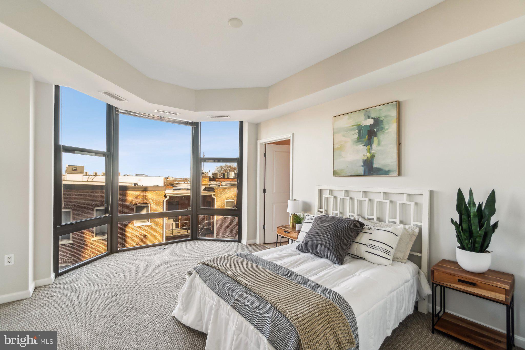 1390 Kenyon Street Northwest, Unit 510 Washington, DC 20010 - Photo 9 of 39 a bedroom with a large bed and a couch