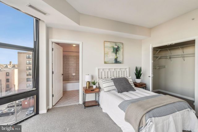 a bedroom with a bed and a painting on the wall