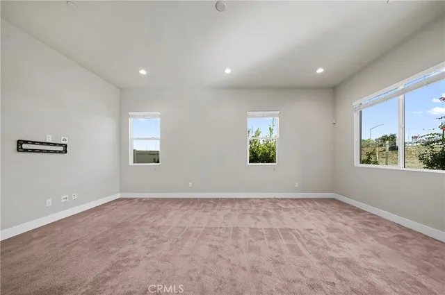 a view of a big room with chandelier and windows