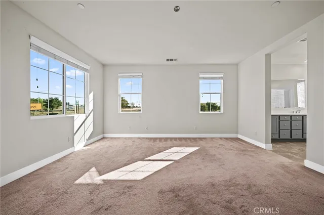 a view of a living room hardwood floor and a kitchen