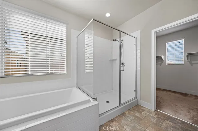 a bathroom with a double vanity sink mirror and bathtub