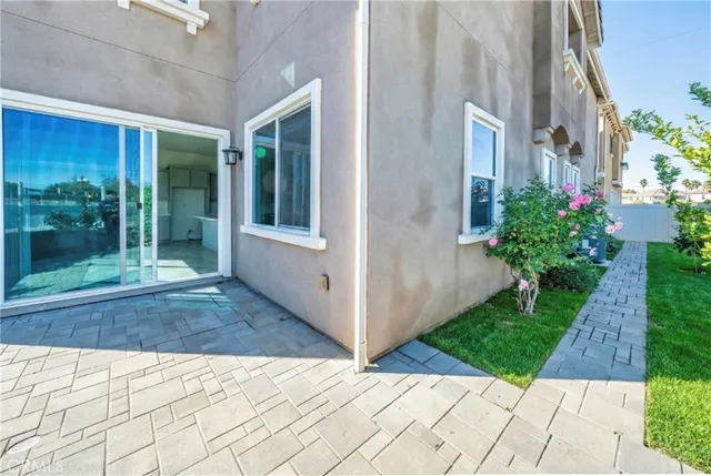 a view of a white house with a yard and garage