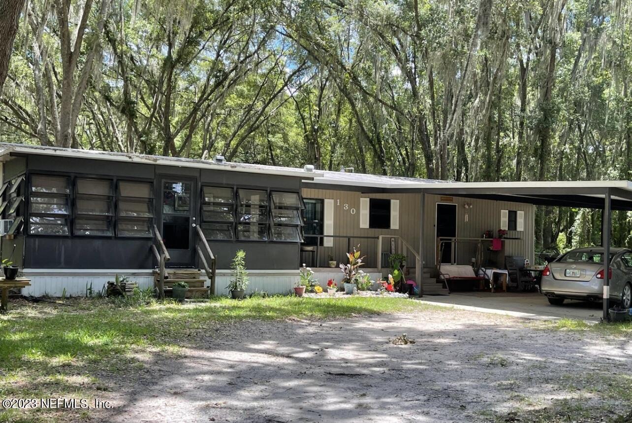 a view of a house with a backyard and a patio