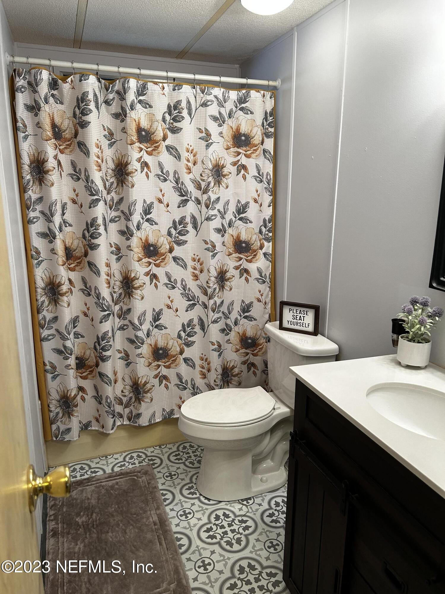 130 Walker Drive Interlachen, FL 32148 - Photo 11 of 31 a bathroom with a sink toilet and a mirror