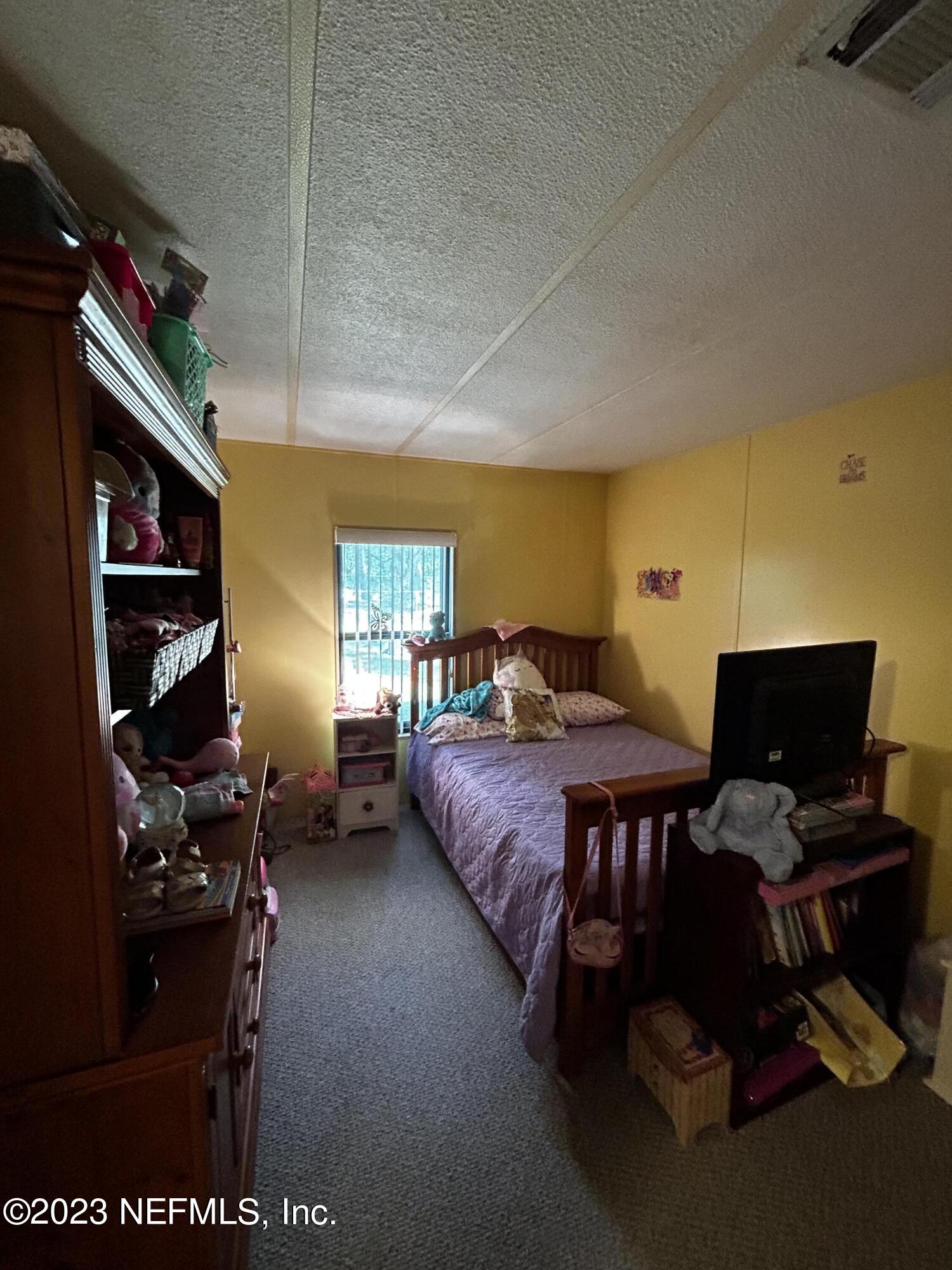 130 Walker Drive Interlachen, FL 32148 - Photo 13 of 31 a bedroom with a bed and closet