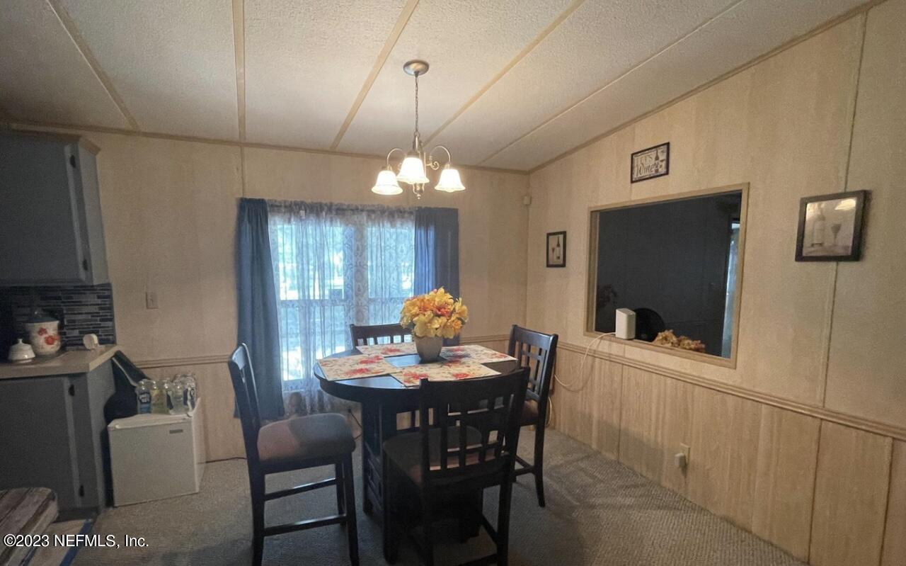 130 Walker Drive Interlachen, FL 32148 - Photo 21 of 31 a dining room with furniture a chandelier and window