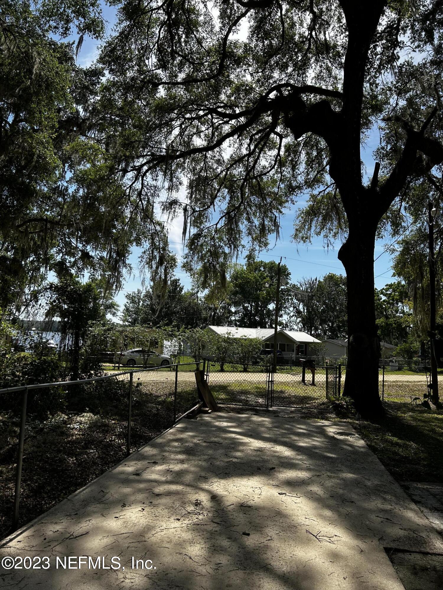 130 Walker Drive Interlachen, FL 32148 - Photo 7 of 31 a view of outdoor space with lots of swings and slides