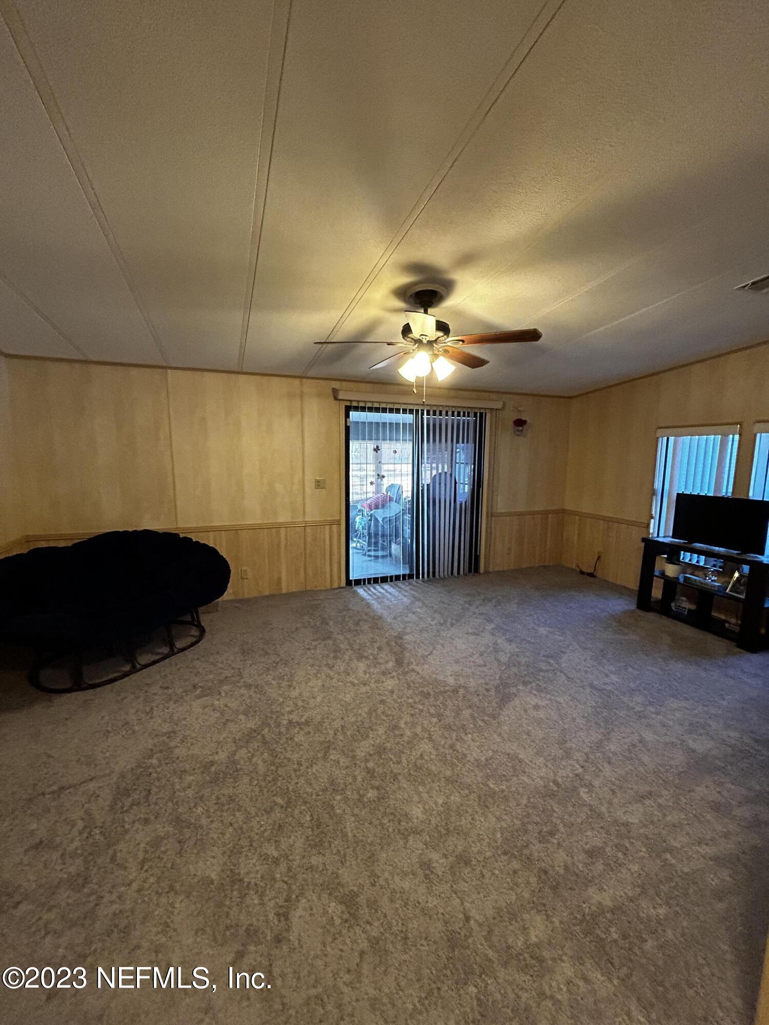 130 Walker Drive Interlachen, FL 32148 - Photo 9 of 31 a view of a livingroom with furniture and chandelier