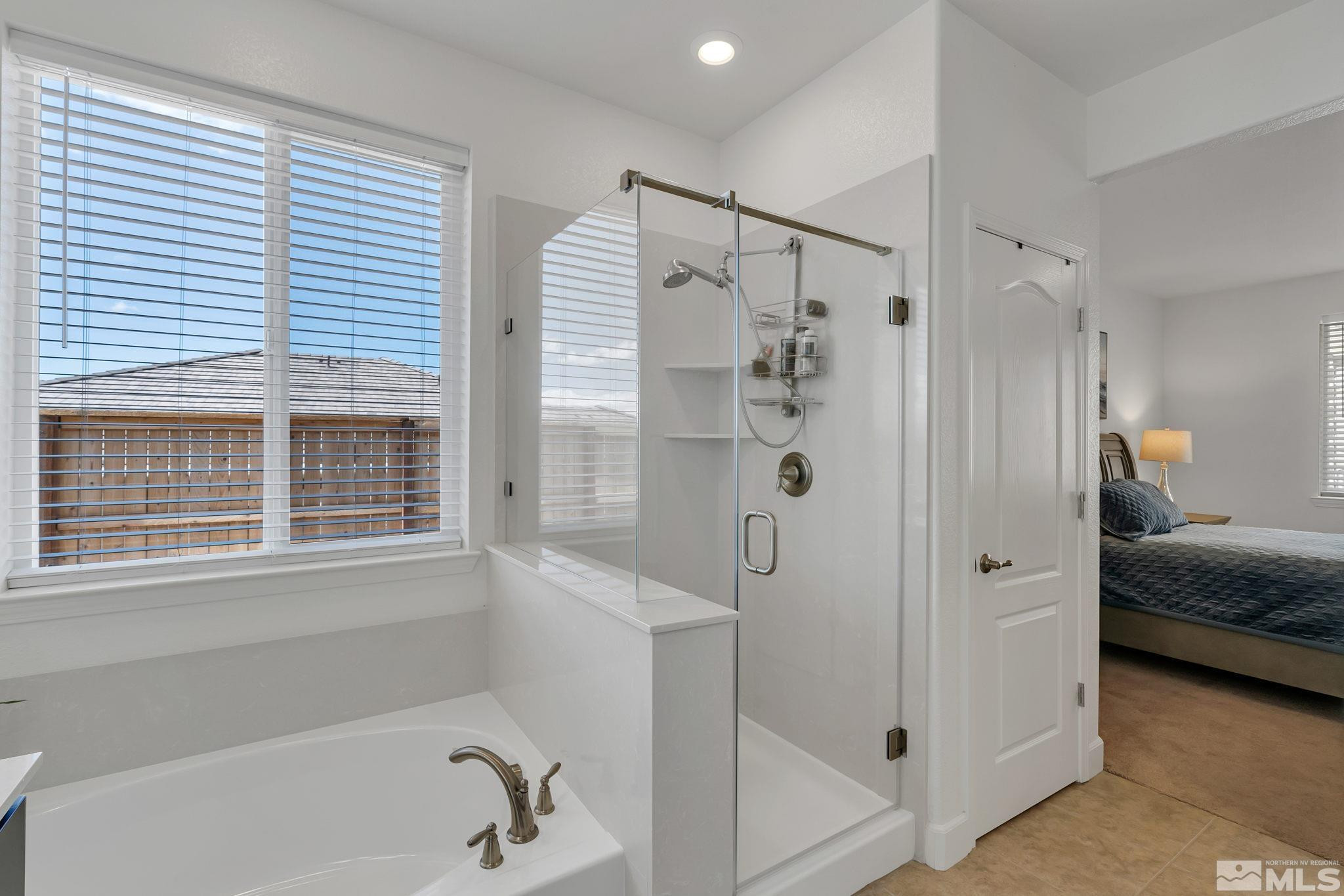 10490 Gold Mine Drive Reno, NV 89521 - Photo 22 of 40 a bathroom with a tub shower and window