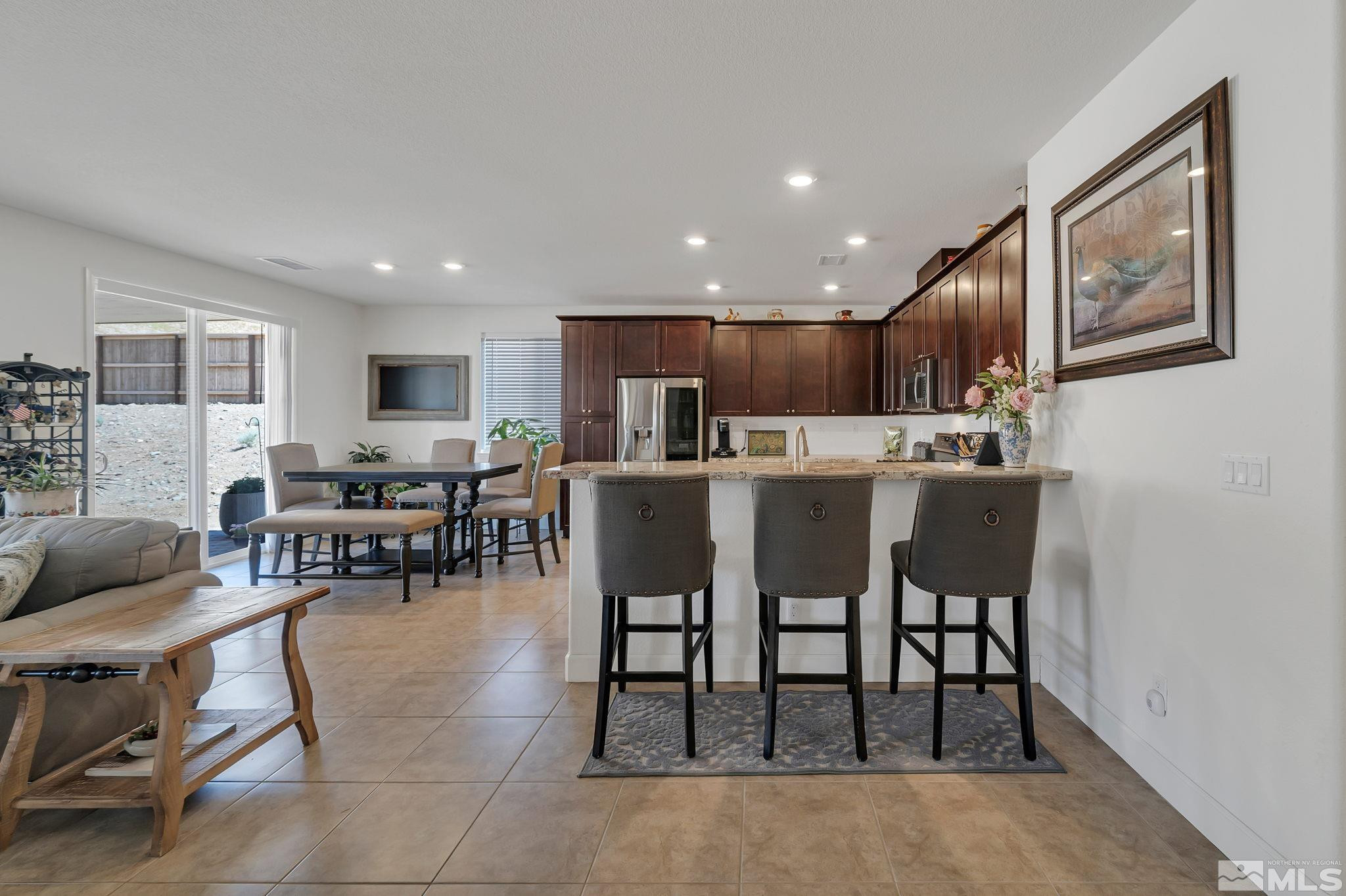 10490 Gold Mine Drive Reno, NV 89521 - Photo 10 of 40 a living room with stainless steel appliances furniture a dining table and kitchen view