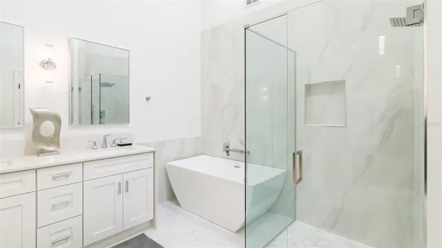 a bathroom with a double vanity sink mirror and bathtub